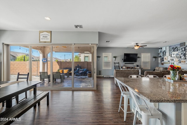 dining space featuring ceiling fan, dark hardwood / wood-style flooring, and a healthy amount of sunlight