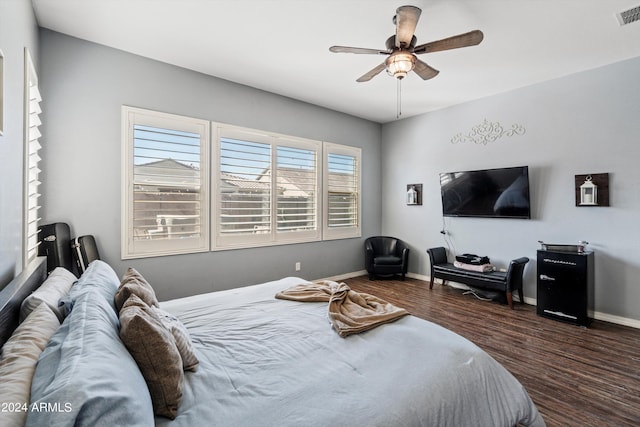 bedroom with dark hardwood / wood-style floors and ceiling fan