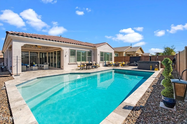 view of pool with a patio and ceiling fan