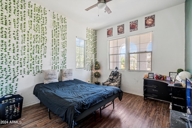 bedroom with dark hardwood / wood-style flooring and ceiling fan