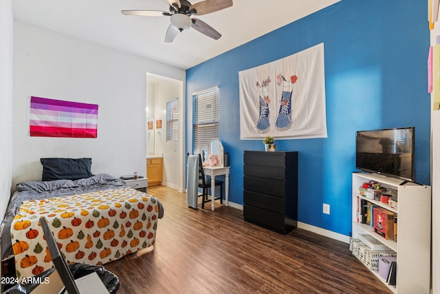 bedroom with ceiling fan, ensuite bathroom, and dark wood-type flooring