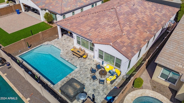 view of pool with a fire pit, a patio, and a hot tub