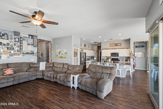 living room featuring dark hardwood / wood-style floors and ceiling fan