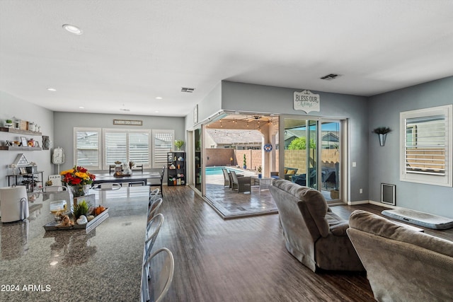 living room with a wealth of natural light and wood-type flooring