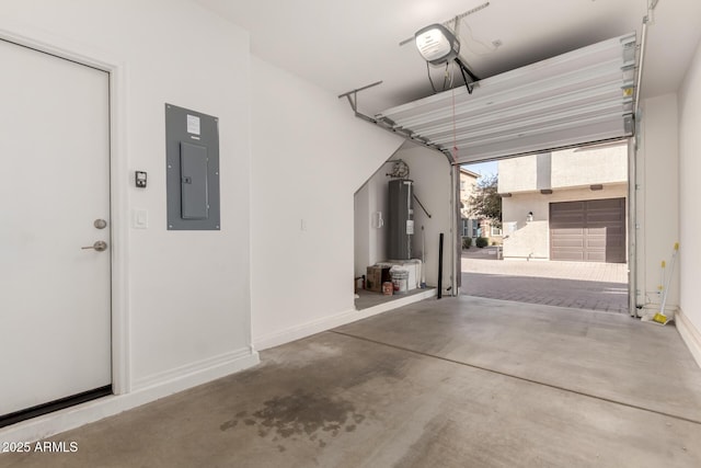 garage featuring a garage door opener, electric panel, and electric water heater