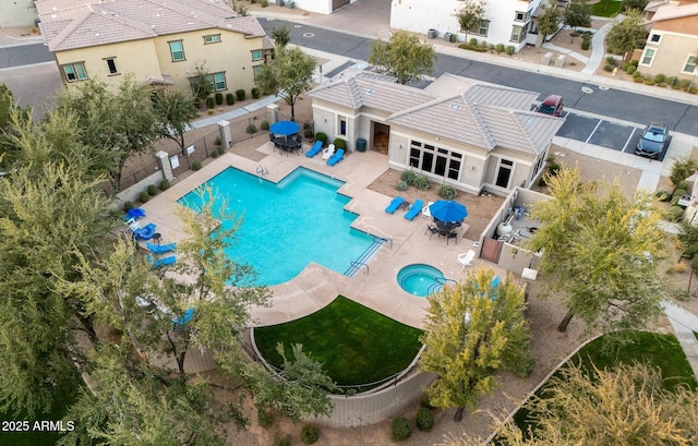 view of pool with a community hot tub and a patio area