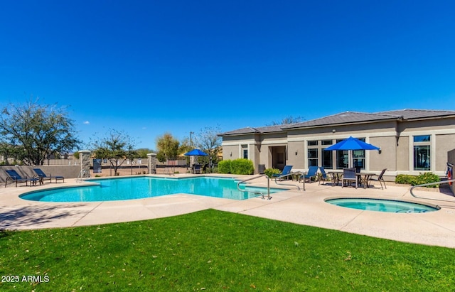 view of swimming pool with a yard, a patio area, and an in ground hot tub