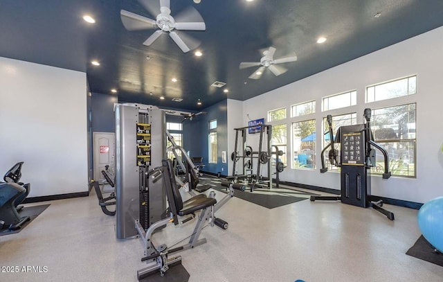 gym with ceiling fan and a towering ceiling