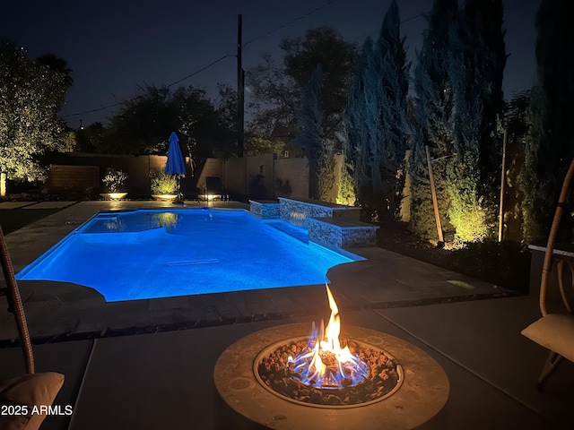 5541 E Cheery Lynn Rd, Phoenix, AZ 85018 - pool at twilight with a fire pit, a patio area, and a fenced backyard