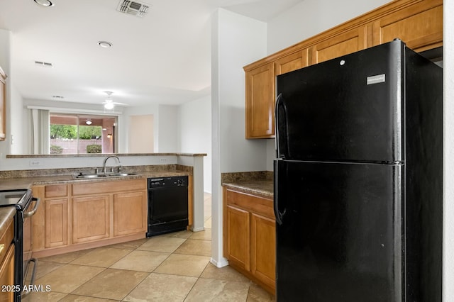 11702 W Lincoln St, Avondale, AZ 85323 - kitchen with black appliances, a sink, a peninsula, ceiling fan, and light tile patterned floors
