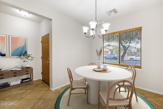 11702 W Lincoln St, Avondale, AZ 85323 - dining space featuring a chandelier, baseboards, and light tile patterned floors