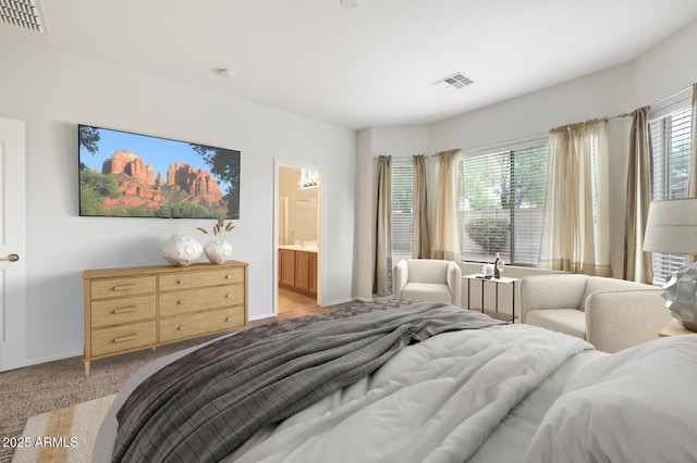 11702 W Lincoln St, Avondale, AZ 85323 - bedroom with light colored carpet, multiple windows, baseboards, and ensuite bathroom