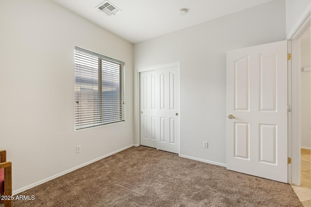 11702 W Lincoln St, Avondale, AZ 85323 - unfurnished bedroom with light carpet, a closet, and baseboards