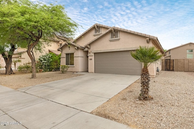 11702 W Lincoln St, Avondale, AZ 85323 - view of front of home featuring an attached garage, concrete driveway, fence, and stucco siding