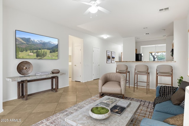 11702 W Lincoln St, Avondale, AZ 85323 - living room featuring light tile patterned floors, baseboards, and a ceiling fan