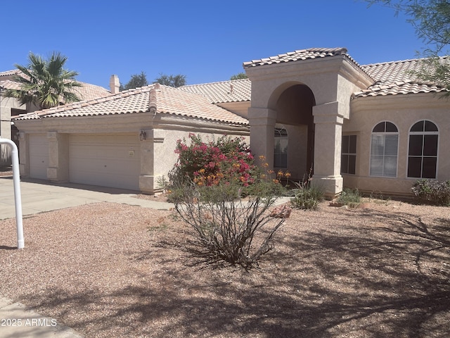 11109 W Amelia Ave, Avondale, AZ 85392 - view of front of home with a tile roof, stucco siding, and a garage