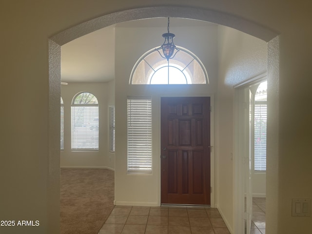 11109 W Amelia Ave, Avondale, AZ 85392 - entrance foyer with light tile patterned floors, light carpet, and arched walkways