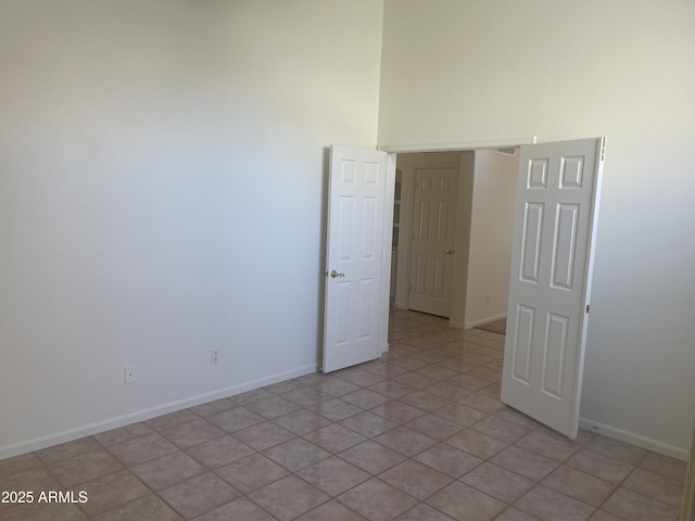 11109 W Amelia Ave, Avondale, AZ 85392 - spare room featuring a towering ceiling and light tile patterned floors