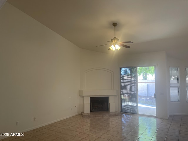 11109 W Amelia Ave, Avondale, AZ 85392 - unfurnished living room with ceiling fan, a fireplace with raised hearth, and light tile patterned flooring