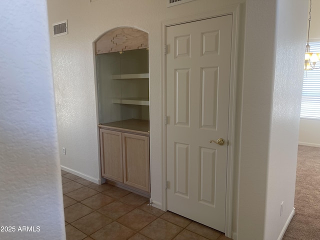 11109 W Amelia Ave, Avondale, AZ 85392 - hallway featuring light tile patterned flooring and arched walkways