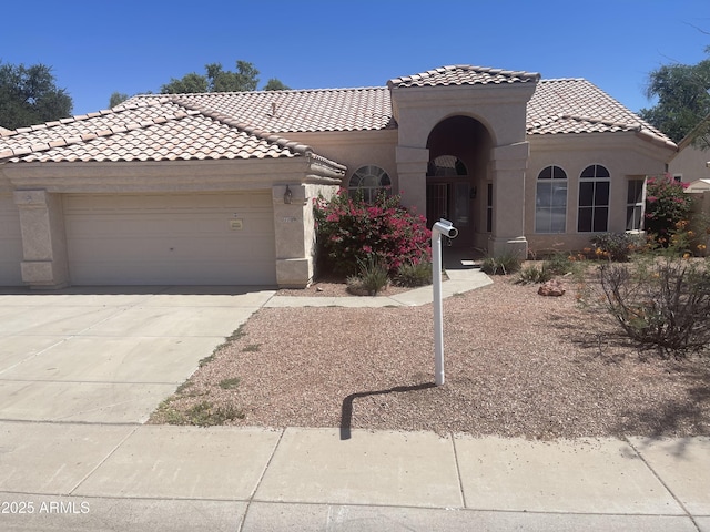 11109 W Amelia Ave, Avondale, AZ 85392 - view of front of house with a tiled roof, stucco siding, a garage, and concrete driveway