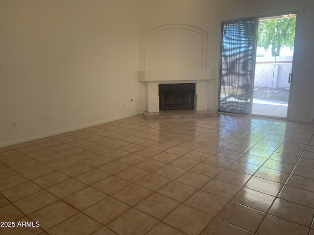 11109 W Amelia Ave, Avondale, AZ 85392 - unfurnished living room with light tile patterned floors and a large fireplace