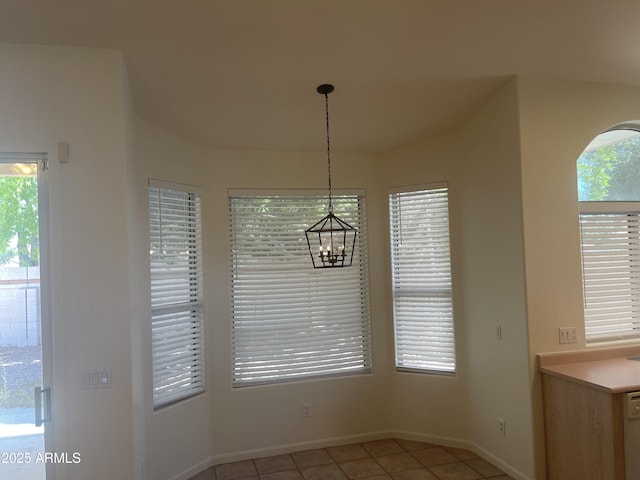 11109 W Amelia Ave, Avondale, AZ 85392 - unfurnished dining area with light tile patterned floors, plenty of natural light, and a chandelier