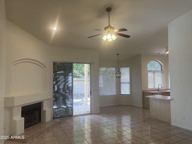 11109 W Amelia Ave, Avondale, AZ 85392 - unfurnished living room with a ceiling fan, a fireplace with raised hearth, light tile patterned floors, and recessed lighting