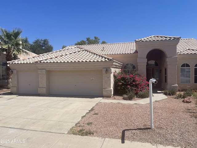 11109 W Amelia Ave, Avondale, AZ 85392 - view of front facade with a tile roof, stucco siding, driveway, and an attached garage