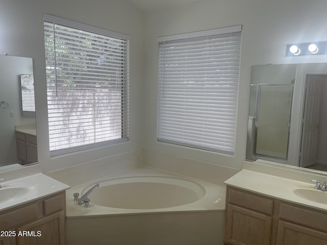 11109 W Amelia Ave, Avondale, AZ 85392 - bathroom featuring a garden tub, two vanities, and a shower stall