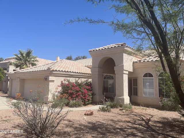 11109 W Amelia Ave, Avondale, AZ 85392 - mediterranean / spanish house with a tiled roof, an attached garage, stucco siding, and concrete driveway