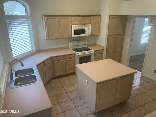 11109 W Amelia Ave, Avondale, AZ 85392 - kitchen with white appliances, light tile patterned floors, light countertops, a center island, and light brown cabinets