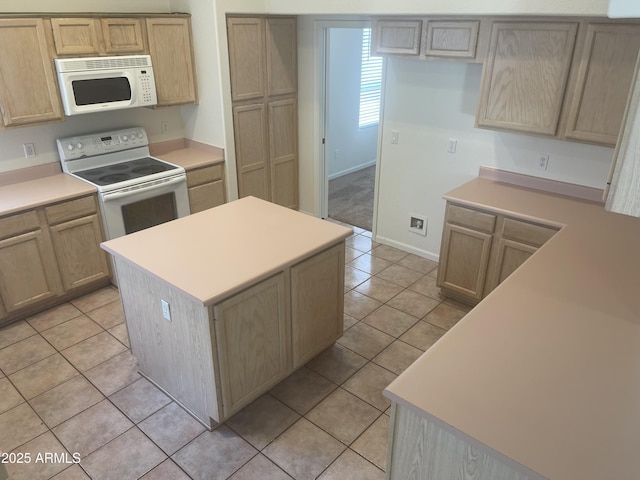 11109 W Amelia Ave, Avondale, AZ 85392 - kitchen featuring white appliances, light tile patterned flooring, a center island, light countertops, and light brown cabinets