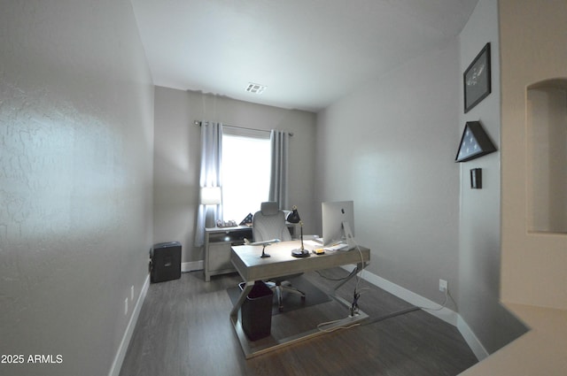 home office featuring visible vents, baseboards, and wood finished floors