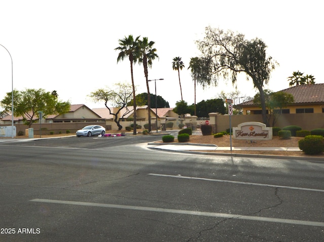 view of street with sidewalks, street lighting, a residential view, and curbs