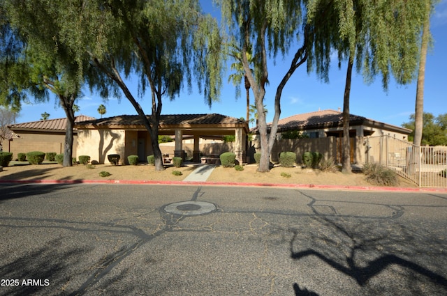 view of front of property with fence and stucco siding