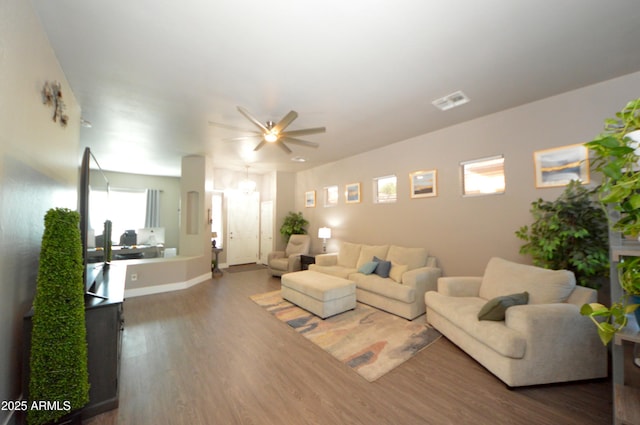 living room featuring ceiling fan, wood finished floors, and visible vents