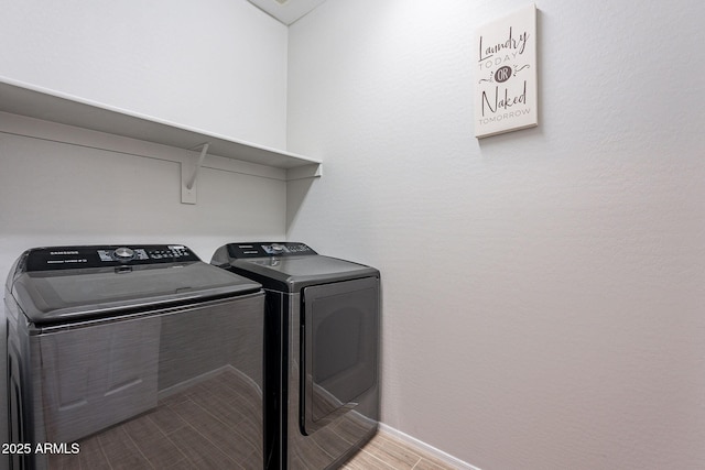 clothes washing area with washer and dryer