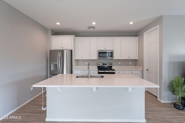 kitchen featuring white cabinetry, an island with sink, and appliances with stainless steel finishes