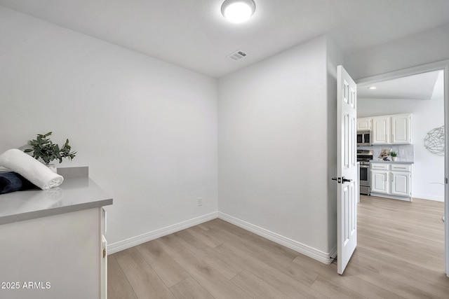 dining space with baseboards, visible vents, and light wood-style floors