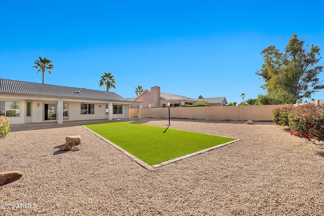 view of yard with a patio area and a fenced backyard