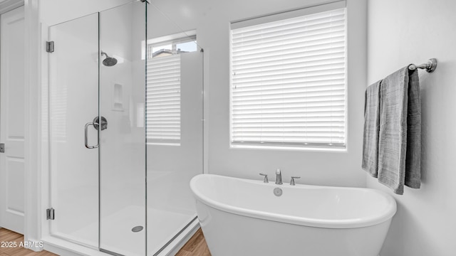 8140 E June St, Mesa, AZ 85207 - bathroom featuring a shower stall, a freestanding bath, and wood finished floors