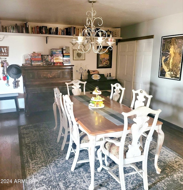 dining area featuring wood finished floors and a chandelier