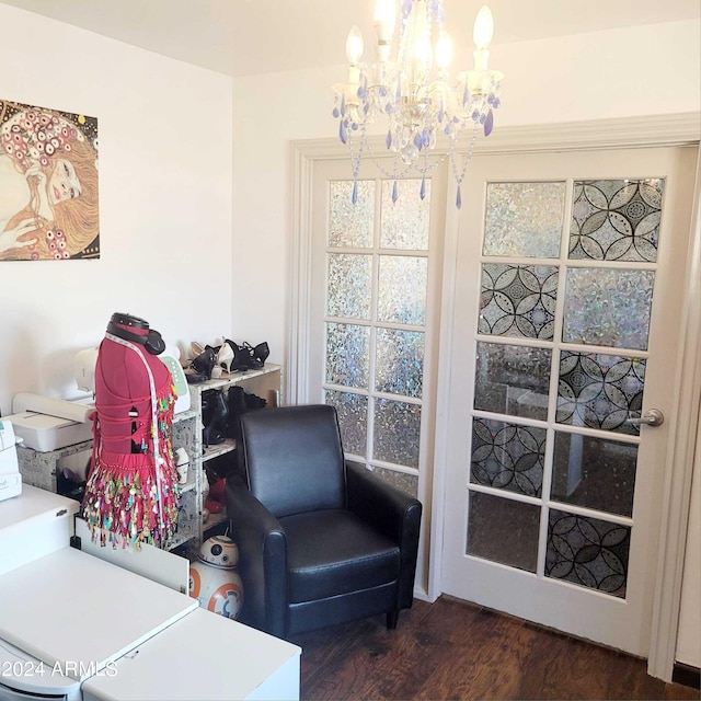 living area featuring dark wood finished floors and a notable chandelier