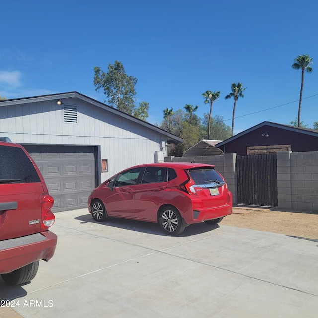 exterior space with concrete driveway and fence