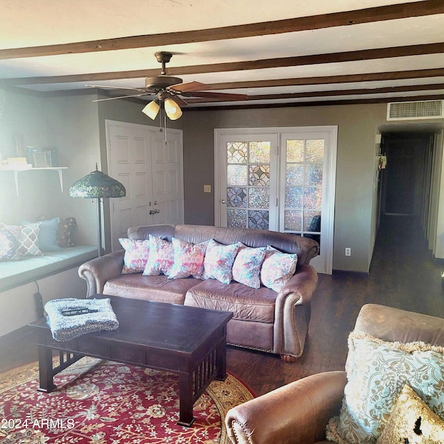 living room with ceiling fan, visible vents, beam ceiling, and wood finished floors