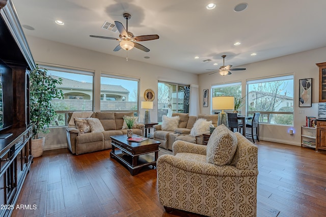 living room with recessed lighting, visible vents, dark wood-type flooring, ceiling fan, and baseboards