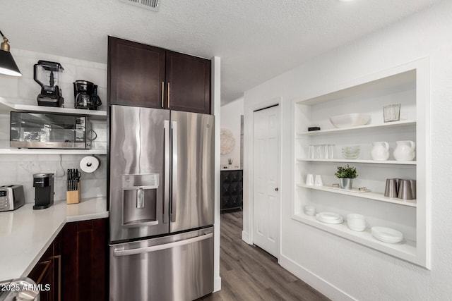 kitchen featuring dark wood-style flooring, stainless steel appliances, open shelves, dark brown cabinetry, and a textured ceiling