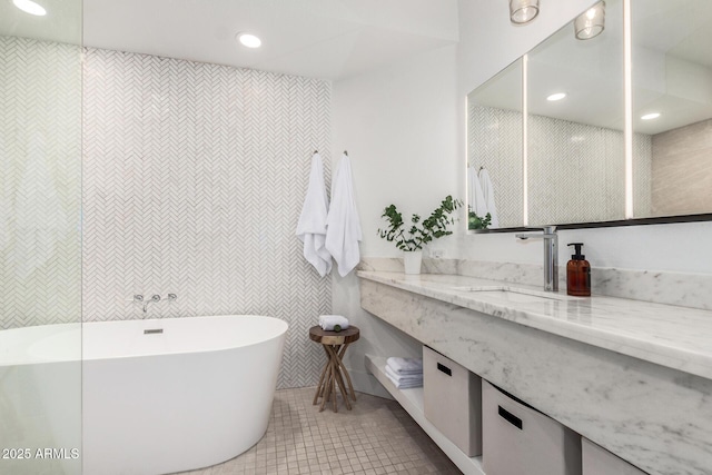 bathroom with tile patterned floors, vanity, recessed lighting, and a freestanding bath