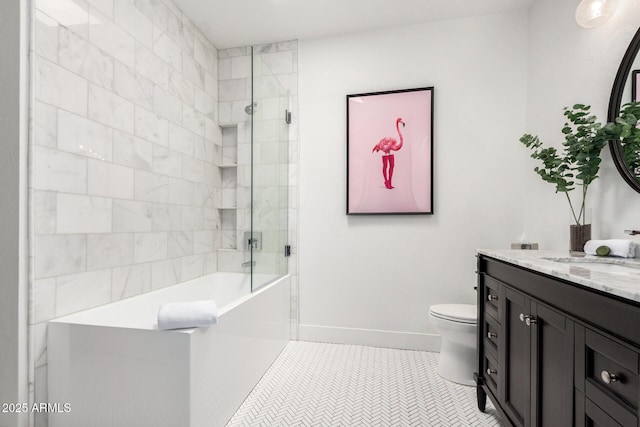 full bath featuring walk in shower, toilet, a tub to relax in, vanity, and baseboards